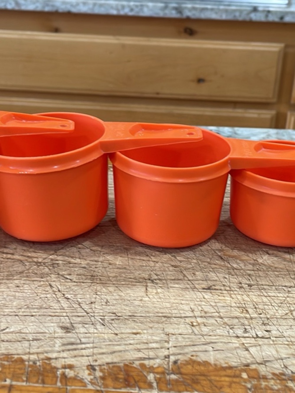 Orange Tupperware measuring cup set